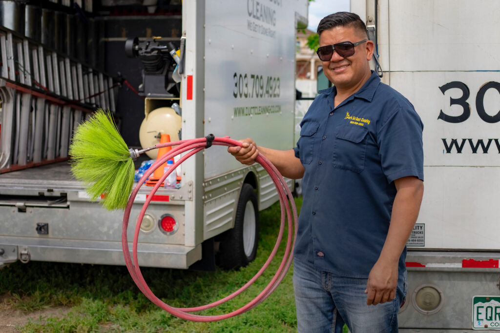 Technician holding equipment - FAQ - Broomfield Air Duct Cleaning